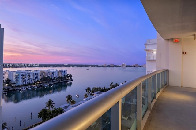 balcony with a water view and a city view