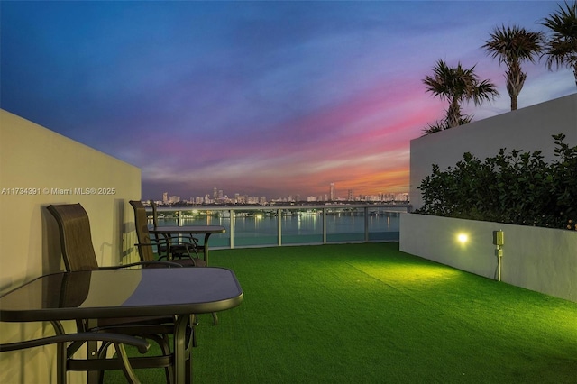 view of yard with a balcony and a water view