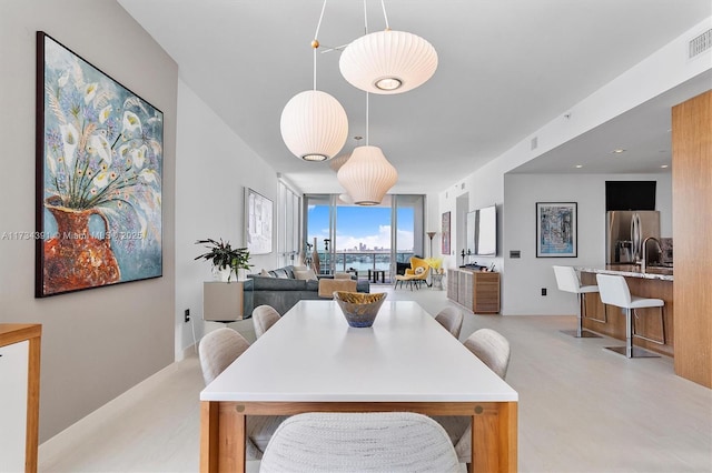 dining area featuring a wall of windows and visible vents