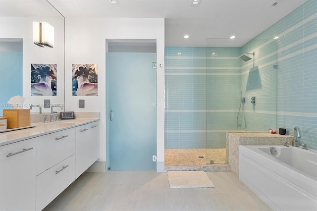 full bathroom featuring a bath, recessed lighting, a stall shower, and vanity