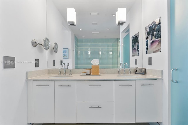 full bathroom with a shower stall, double vanity, visible vents, and a sink