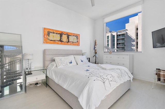 bedroom with baseboards and wood finished floors