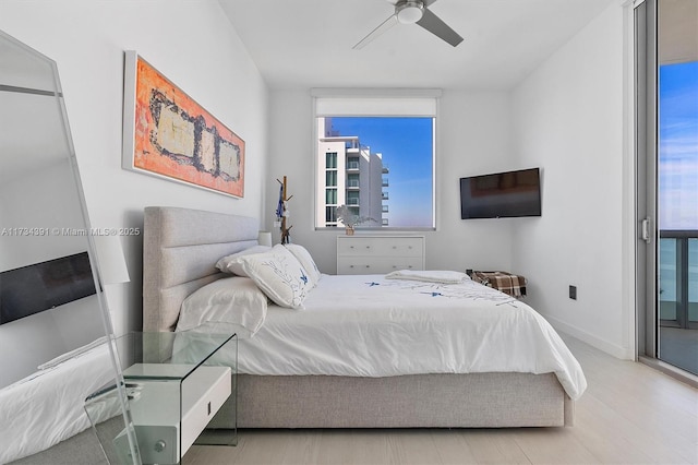 bedroom with access to exterior, a ceiling fan, and baseboards