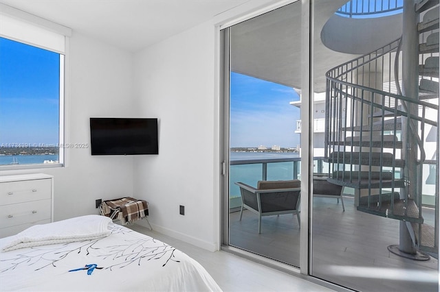 bedroom featuring a wall of windows and baseboards