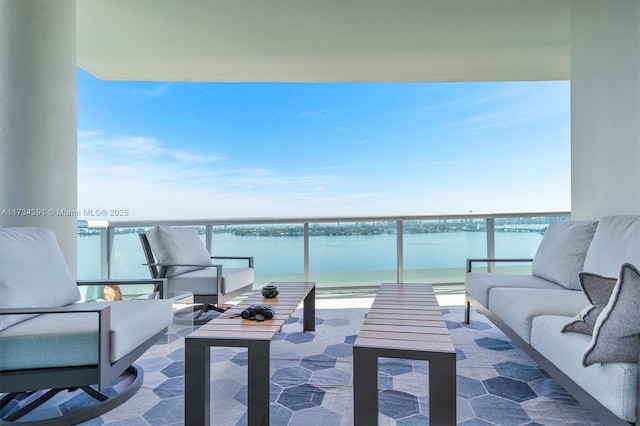 balcony featuring a water view and an outdoor hangout area