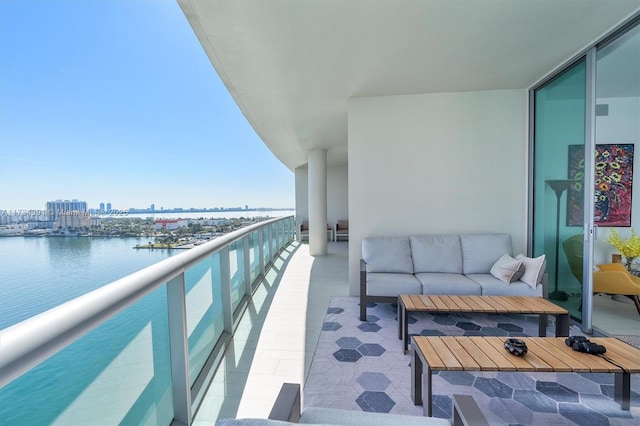 balcony featuring a water view, a city view, and outdoor lounge area