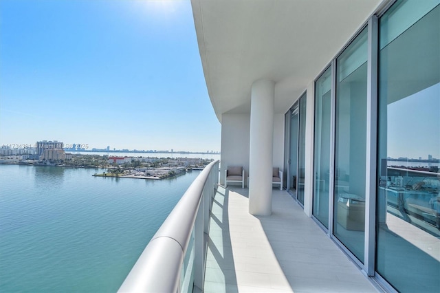 balcony featuring a view of city and a water view