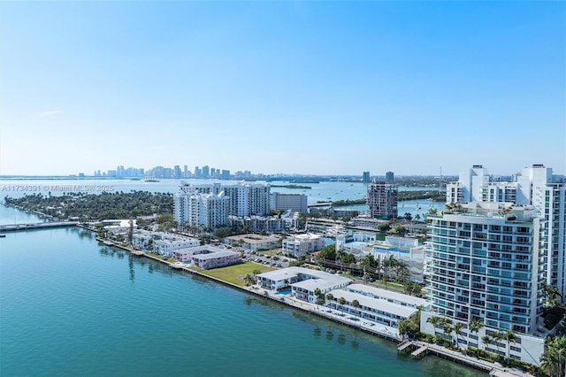 birds eye view of property with a view of city and a water view