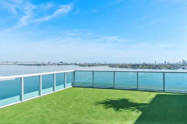 exterior space featuring a water view, a balcony, and a city view