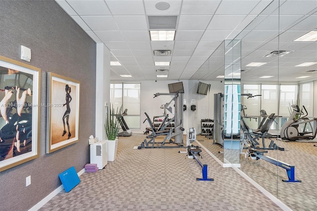 gym featuring visible vents and a paneled ceiling