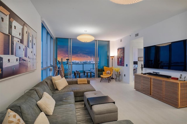 living room with visible vents and floor to ceiling windows