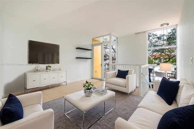 living room featuring light tile patterned floors and expansive windows