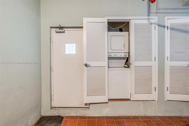 8041 Harding Ave Unit 105, Miami Beach, FL 33141 - laundry room featuring laundry area, stacked washing maching and dryer, and tile patterned flooring