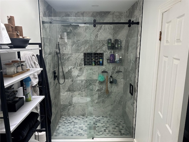 bathroom with a shower with door