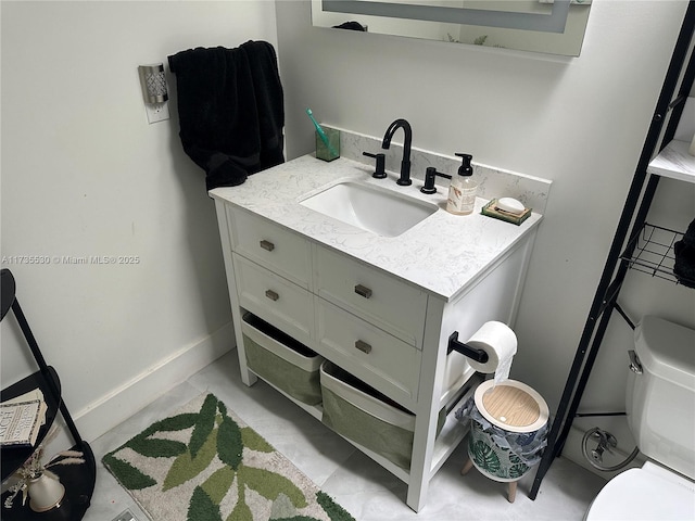 bathroom with vanity and toilet