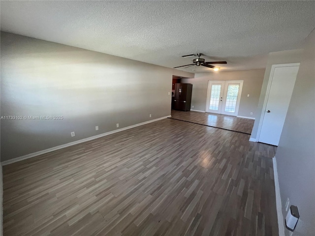 interior space with ceiling fan, dark hardwood / wood-style floors, and a textured ceiling