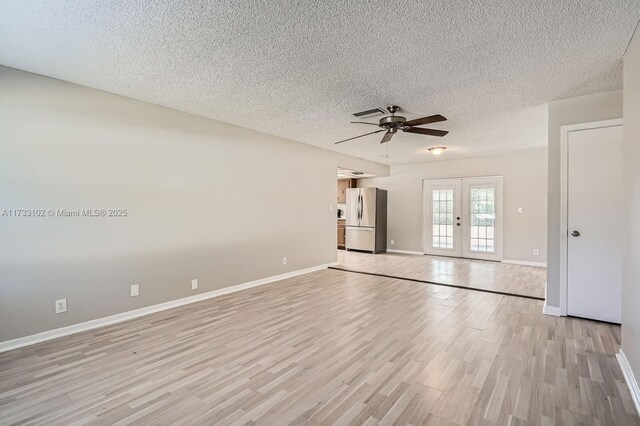 kitchen with tasteful backsplash, sink, black appliances, a drop ceiling, and light wood-type flooring