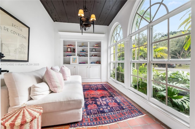 sitting room featuring wooden ceiling and a chandelier