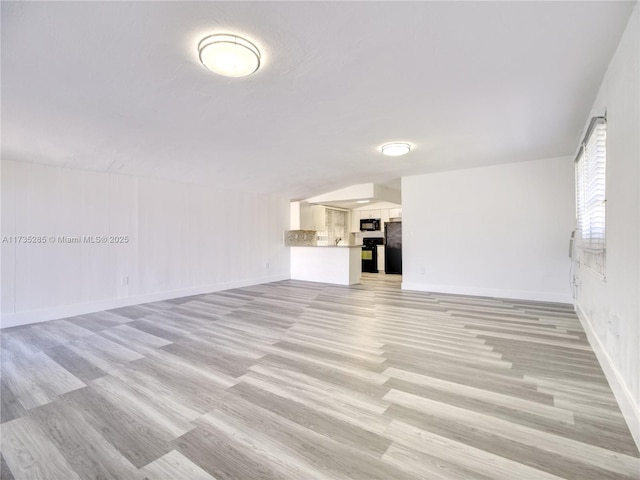 unfurnished living room featuring light hardwood / wood-style flooring