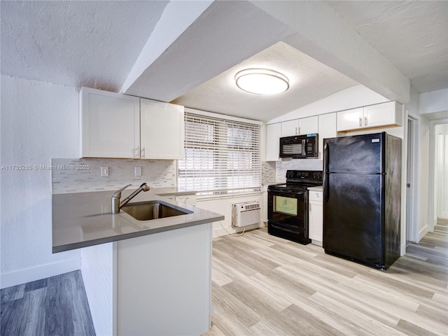 kitchen featuring black appliances, sink, white cabinets, kitchen peninsula, and light wood-type flooring