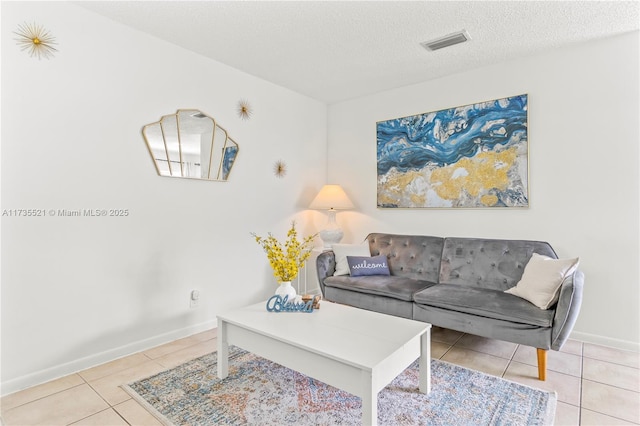 living room with light tile patterned floors and a textured ceiling