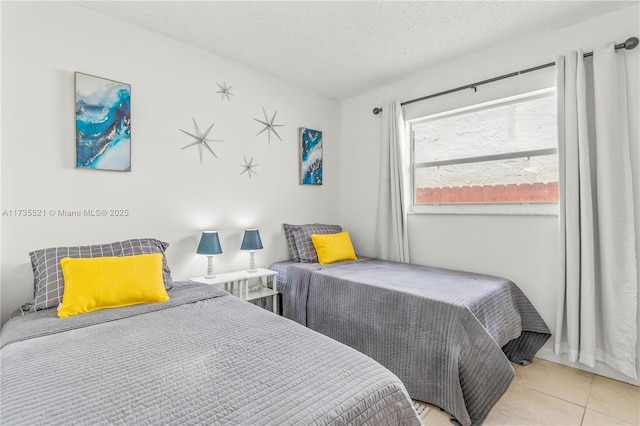 bedroom featuring a textured ceiling and light tile patterned floors