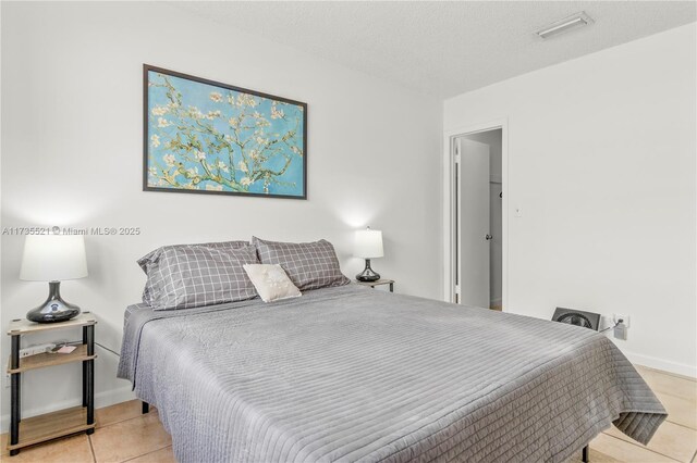 bedroom with a spacious closet and a textured ceiling