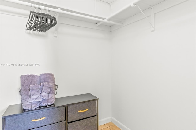 spacious closet featuring light tile patterned floors