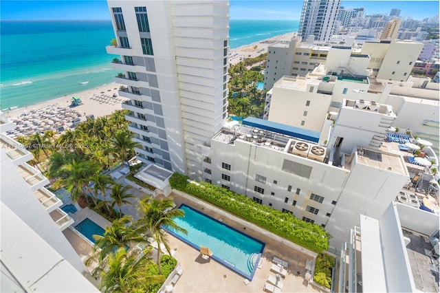 birds eye view of property with a beach view and a water view