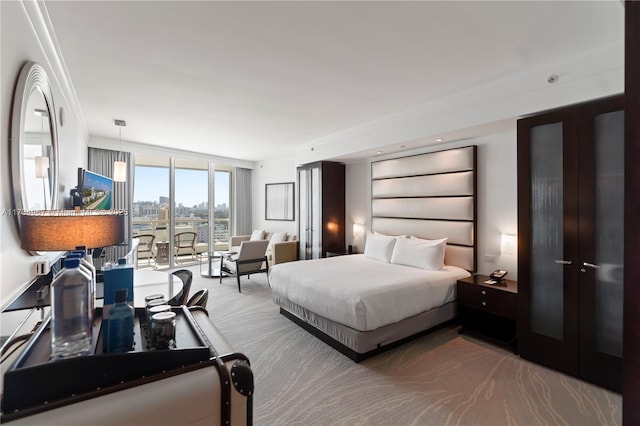 bedroom featuring access to outside, carpet, and expansive windows