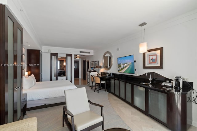 bedroom featuring sink and crown molding