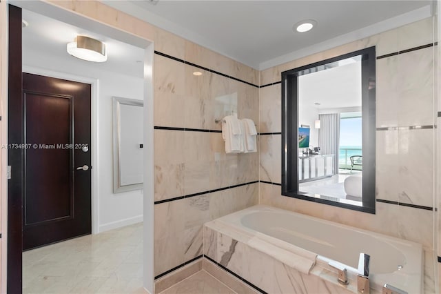 bathroom featuring tiled bath and tile walls