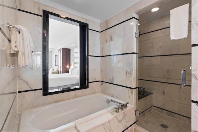 bathroom featuring separate shower and tub and tile walls