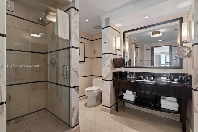 bathroom featuring toilet, tile walls, vanity, and walk in shower