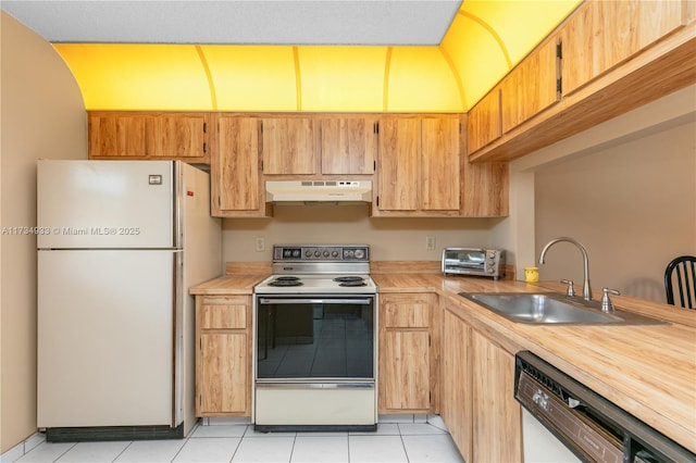 kitchen with light tile patterned flooring, white appliances, and sink