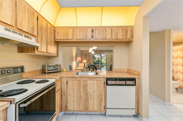 kitchen with light brown cabinetry, sink, white appliances, and light tile patterned floors