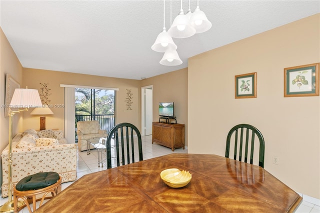 tiled dining space featuring a textured ceiling