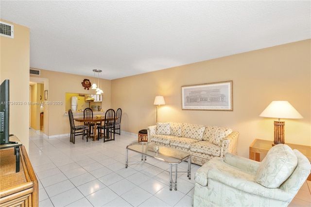 tiled living room with a textured ceiling