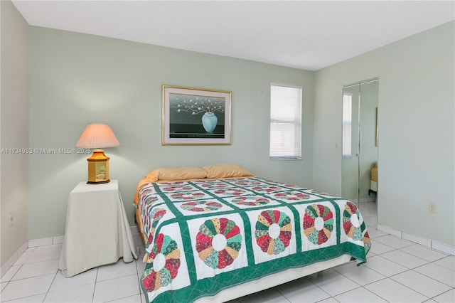 bedroom with light tile patterned floors and a textured ceiling