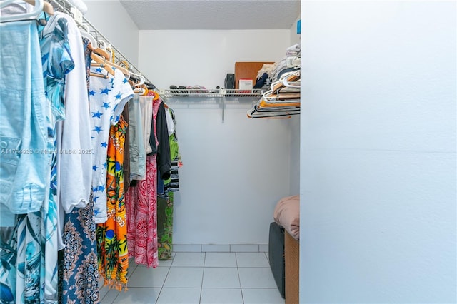 spacious closet featuring light tile patterned floors