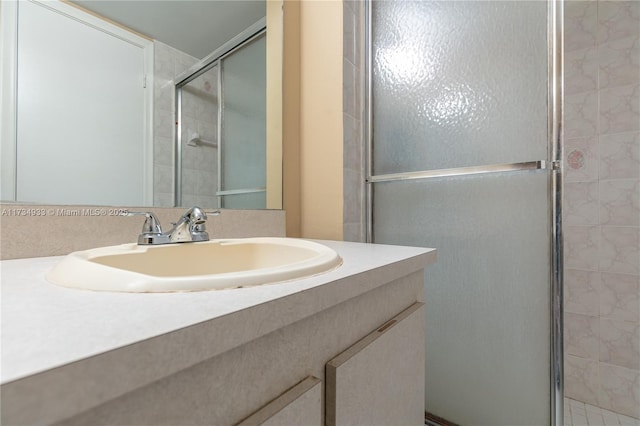 bathroom with an enclosed shower and vanity