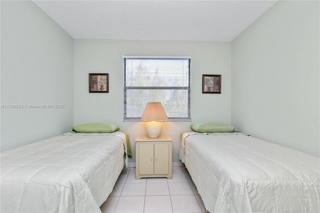 tiled bedroom featuring a textured ceiling