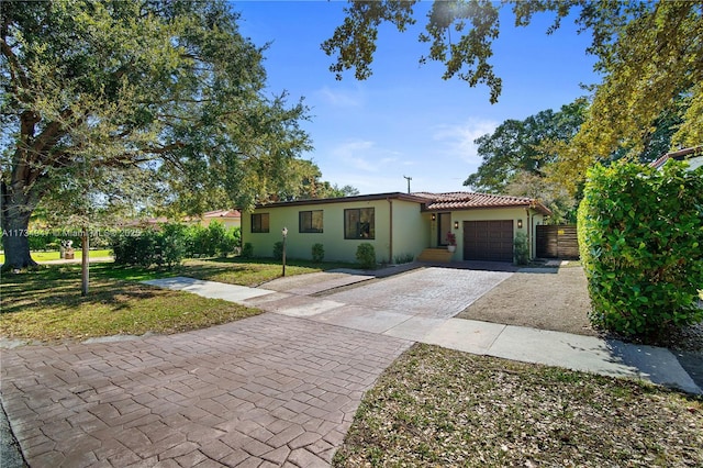 view of front of house featuring a garage and a front lawn