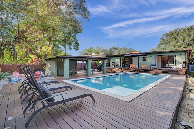 view of swimming pool with a patio area, fence, a deck, and a fenced in pool