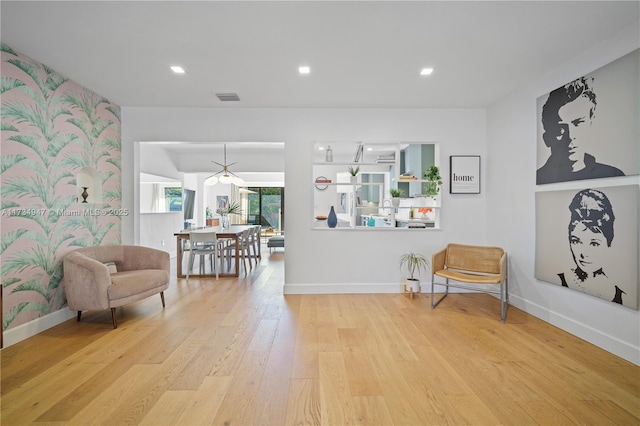 living area featuring recessed lighting, visible vents, baseboards, and wood finished floors