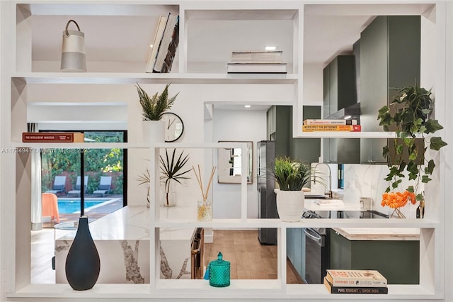 interior space with wood finished floors and freestanding refrigerator