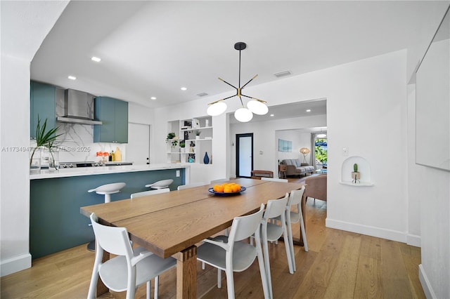 dining area featuring light wood-type flooring, baseboards, visible vents, and recessed lighting