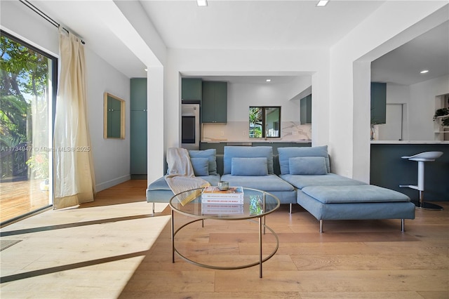 living room with light wood finished floors and baseboards