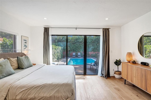 bedroom featuring light wood-type flooring, access to exterior, and multiple windows