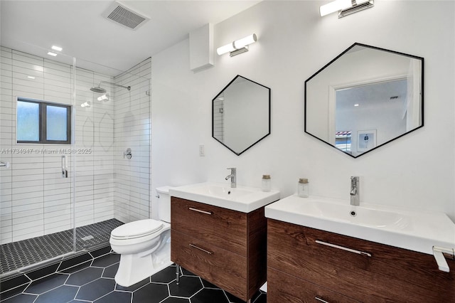 full bathroom featuring visible vents, toilet, a stall shower, a sink, and tile patterned flooring